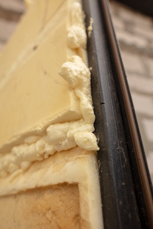 Construction foam in the cracks of the wall at the construction site .の写真素材