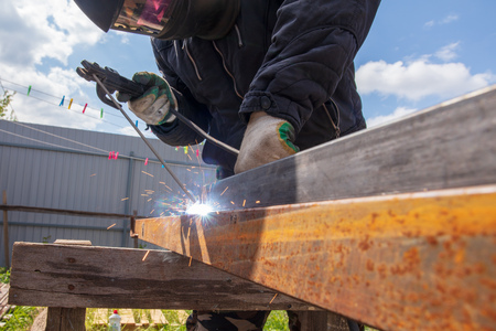 Welder welds metal at the construction site .