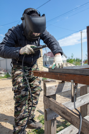 Welder welds metal at the construction site .
