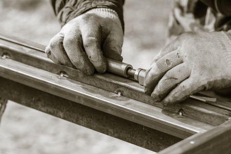 A man makes metal doors in a factory .の写真素材