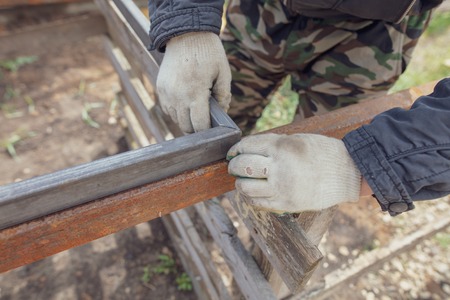 A man makes metal doors in a factory .
