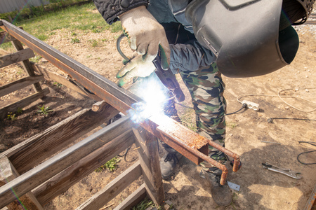 Welder welds metal at the construction site .