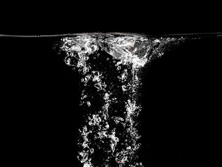 Bubbles of air in water on a black background .の写真素材