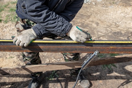 A man makes metal doors in a factory .の写真素材