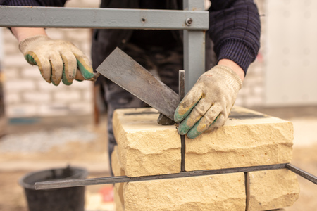 The man at the construction site is laying bricks .の写真素材