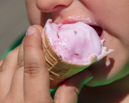 The face of the boy eats ice cream .の写真素材