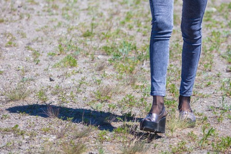 Legs of a girl in jeans in a park .の写真素材
