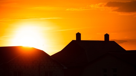 Silhouette of the roof of the house at sunset .の写真素材