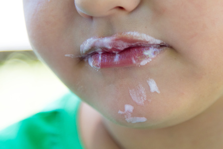 The face of the boy eats ice cream .の写真素材