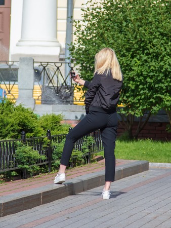 The girl is making a salfi in the park .の写真素材