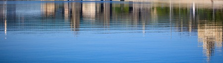 Reflection of a building on the surface of water .