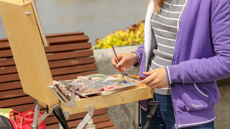 The artist paints a picture in nature .の写真素材