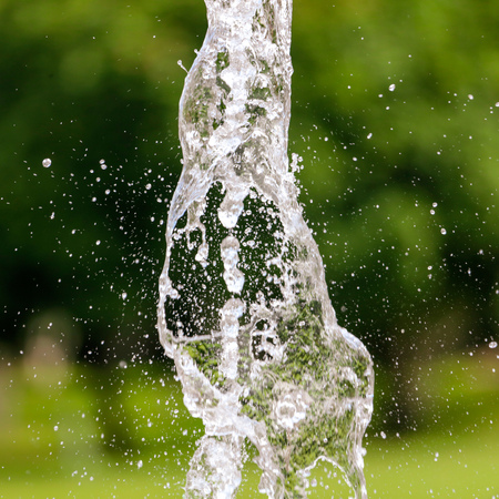 Splashing water against a background of green nature .の写真素材