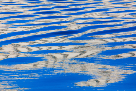 Reflection of a building on the surface of water .