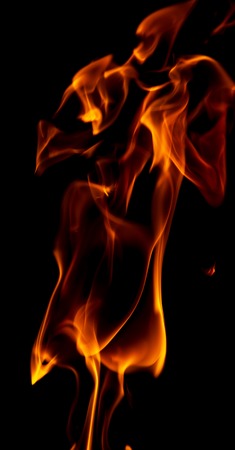 Red flame of fire on a black background .