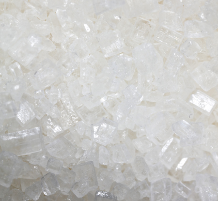 White granulated sugar as a background. Macro