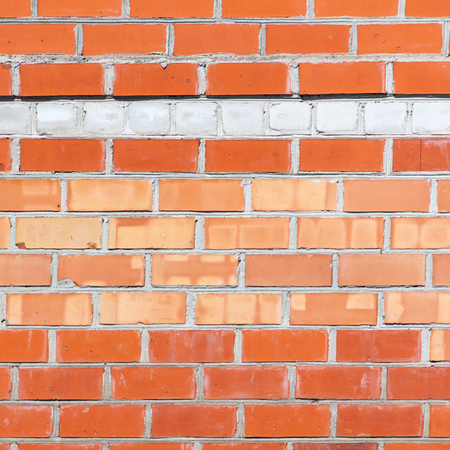 Wall from a red brick as an abstract background .