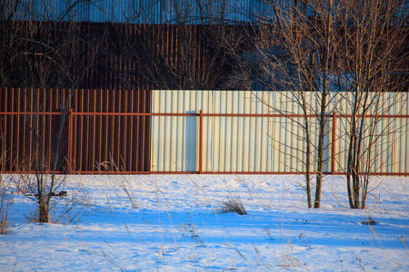 Fence on the site in the village in winter .の写真素材