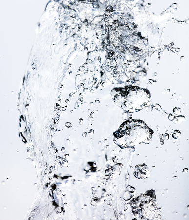 Splashing water with drops on the sky background .の写真素材