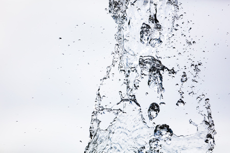 Splashing water with drops on the sky background .の写真素材