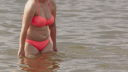 Girl bathing in the water on the beach .の写真素材