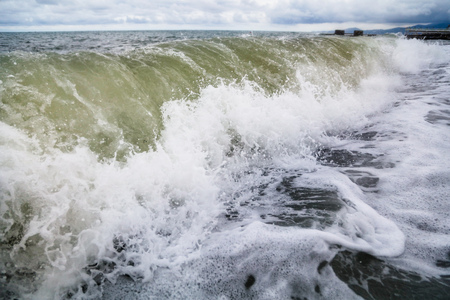 Storm waves on the seashore as a background .