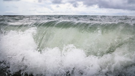 Storm waves on the seashore as a background .