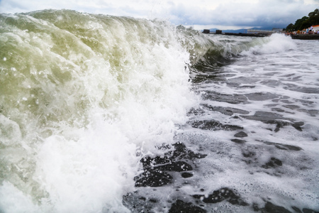 Storm waves on the seashore as a background .
