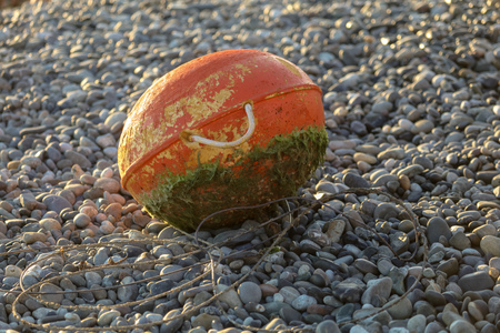 The float lies on a pebble by the sea .の写真素材