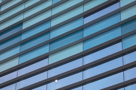 Glass building walls in the rays of sunset as background .