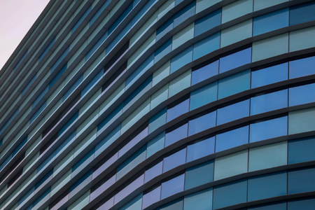 Glass building walls in the rays of sunset as background .