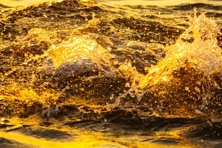 Waves at sea in the rays of sunset .の写真素材