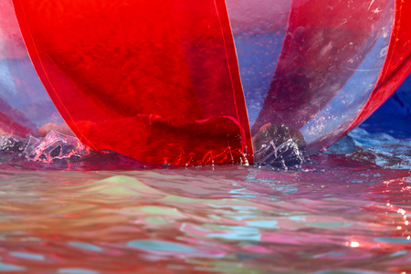 A child is playing in a large bowl on the water .