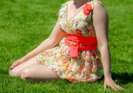 Girl in a dress on the green grass .の写真素材