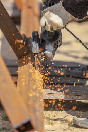 Sparks from cutting metal on the rack .