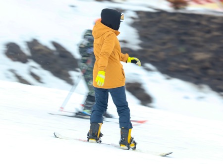 Girl snowboarding from the mountain in winter .の写真素材