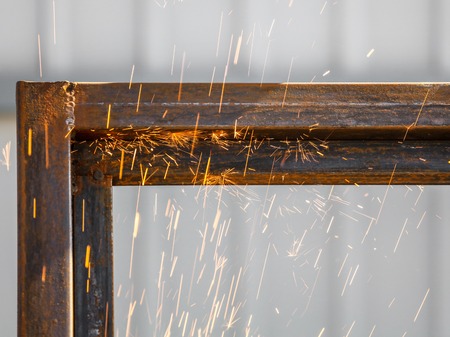 Sparks from cutting metal on the rack .