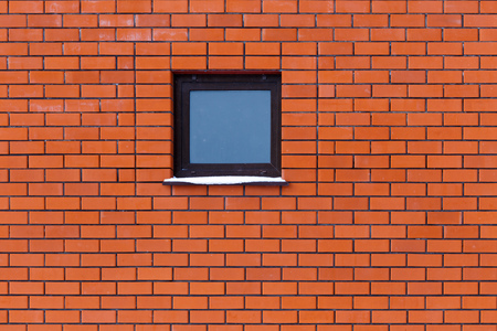 Window on a brick wall in the house .