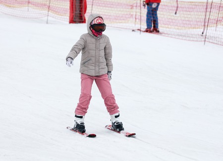Girl skiing from the mountain in winter .の写真素材