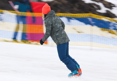 Girl snowboarding from the mountain in winter .の写真素材