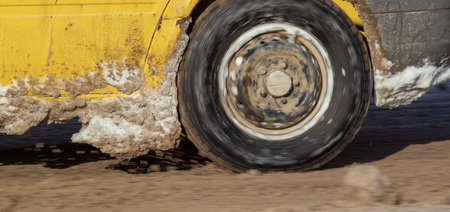 Car wheel in the snow in winter .の写真素材