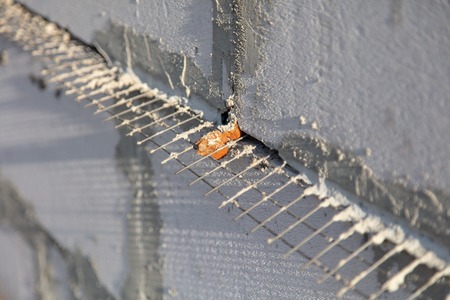 Metal mesh between the bricks in the concrete .の写真素材