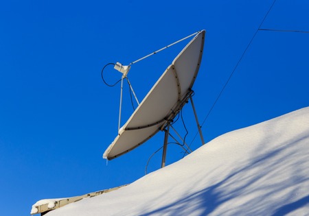 Satellite dish in the snow in winter .の写真素材