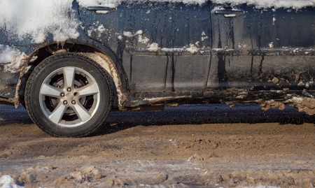Car wheel in the snow in winter .の写真素材