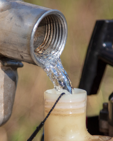 The man pours gasoline into the tank from the canister .の写真素材