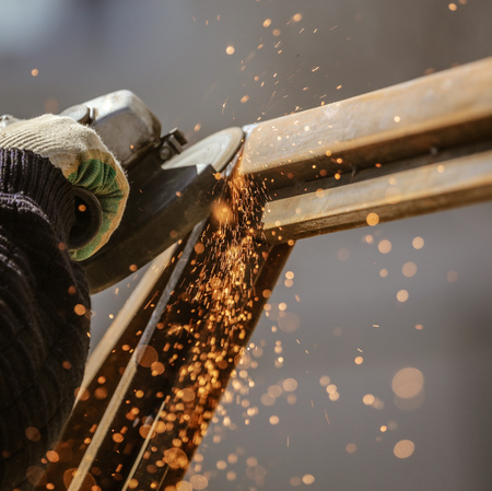 Sparks from cutting metal on the rack .