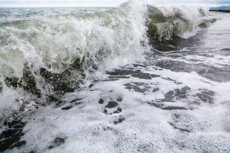 Storm waves on the seashore as a background .