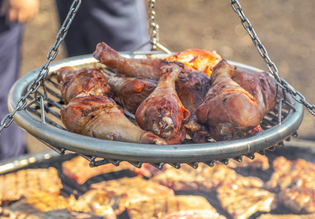 Chef fries meat on the grill in nature .の写真素材