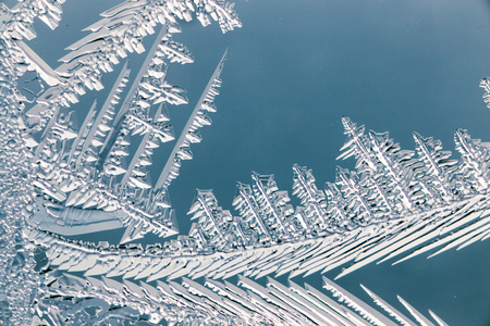 Snow patterns on glass as an abstract background .