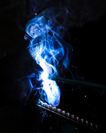 Flame of fire and sparks from welding metal at night .の写真素材